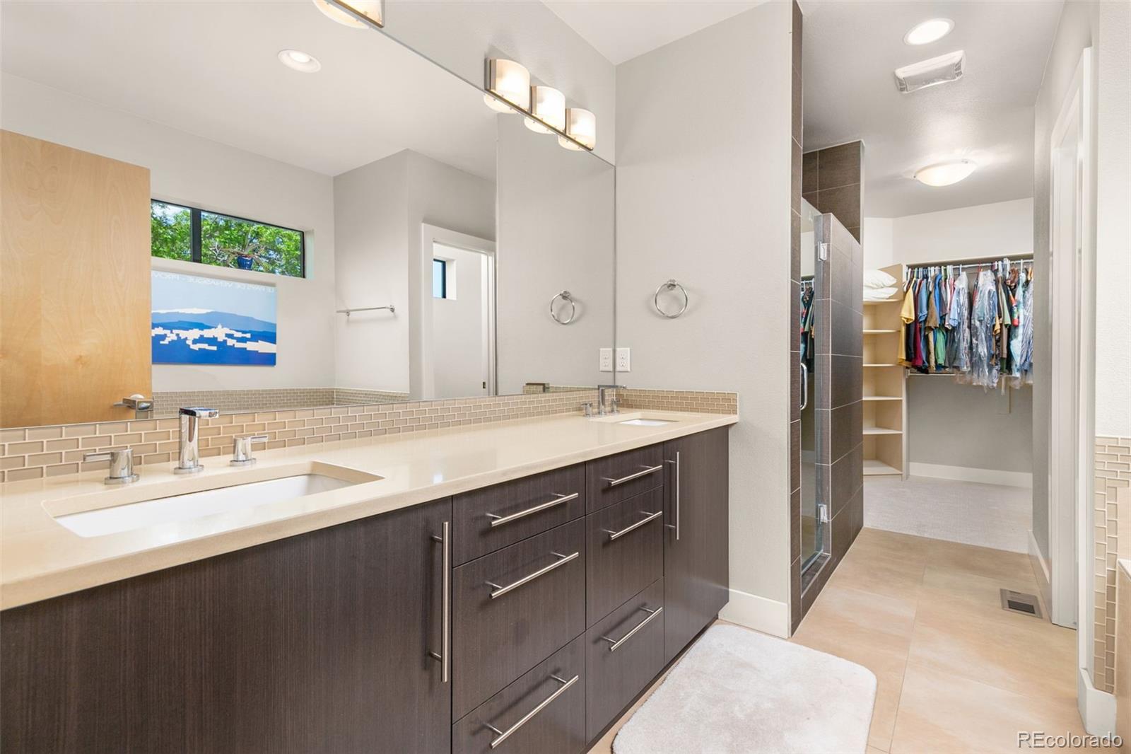 4515 West Moncrieff Place Denver, CO 80212 - Photo 16 of 29 a spacious bathroom with a double vanity sink shower and a mirror