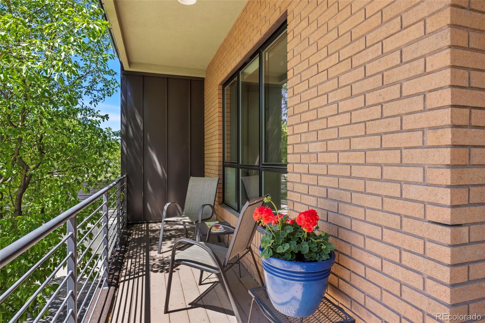 4515 West Moncrieff Place Denver, CO 80212 - Photo 6 of 29 a table and chairs in front of a house