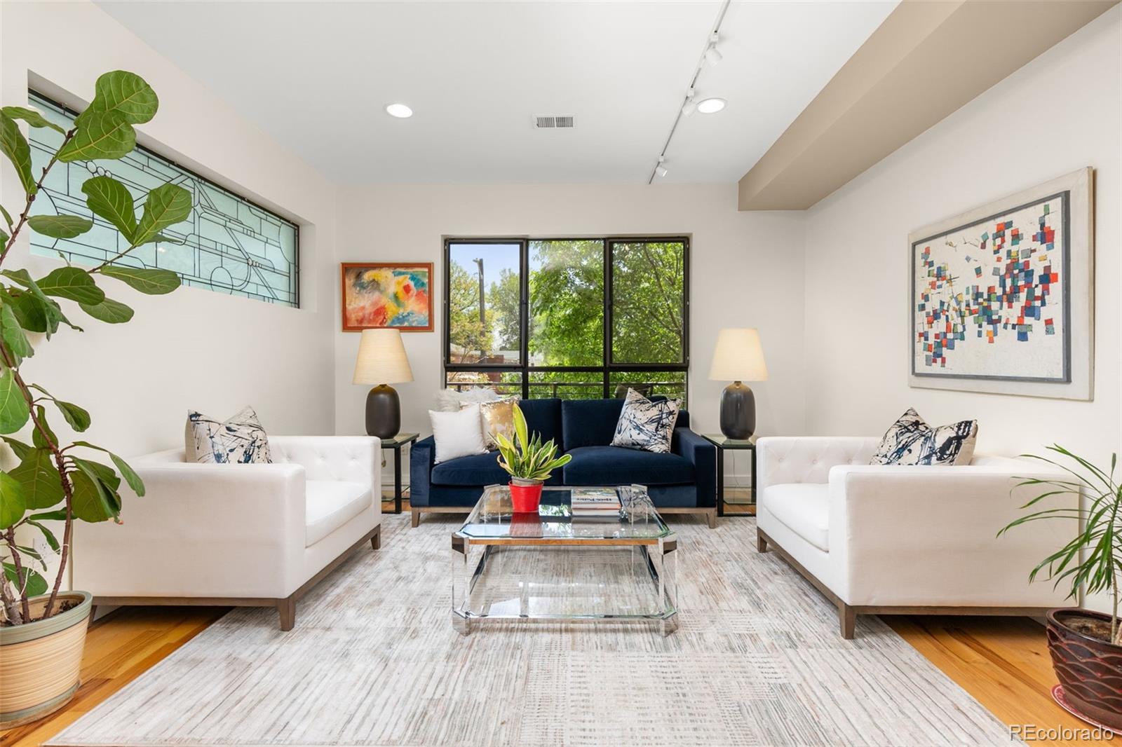 4515 West Moncrieff Place Denver, CO 80212 - Photo 7 of 29 a living room with furniture floor to ceiling window and a potted plant