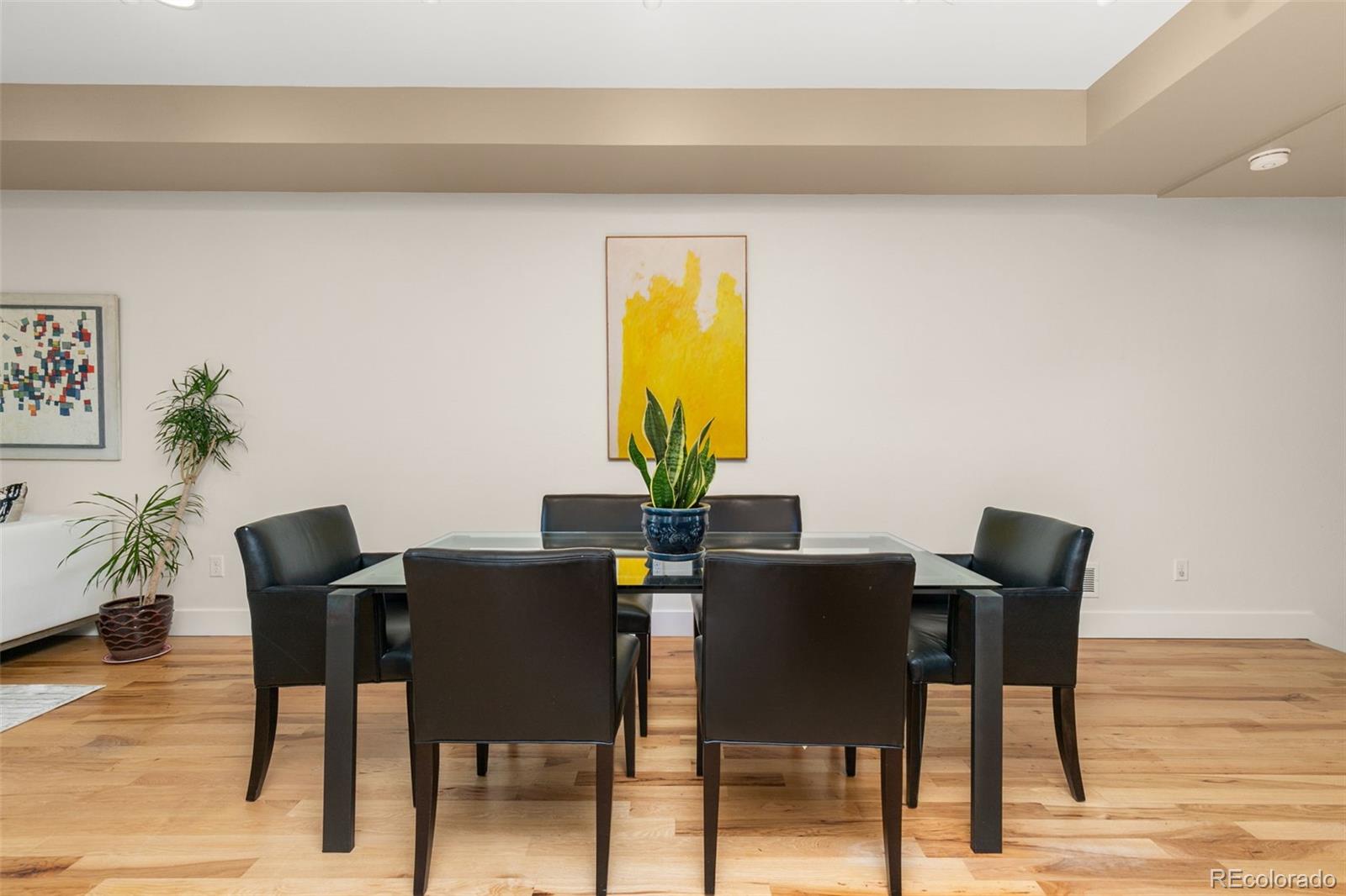 4515 West Moncrieff Place Denver, CO 80212 - Photo 8 of 29 a view of a dining room with furniture and wooden floor