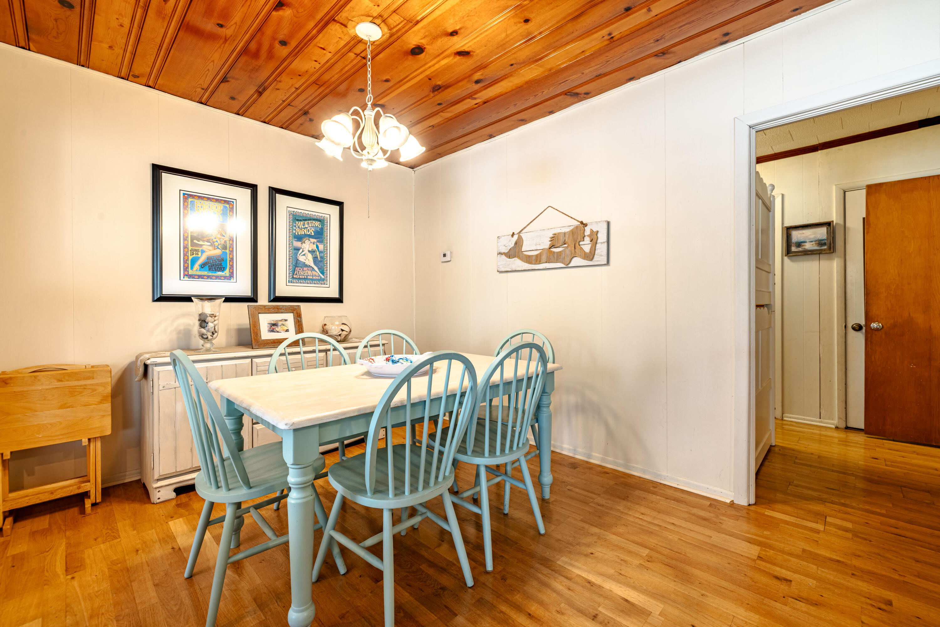 234 Sands Street Panama City Beach, FL 32413 - Photo 12 of 58 a view of a dining room with furniture and wooden floor
