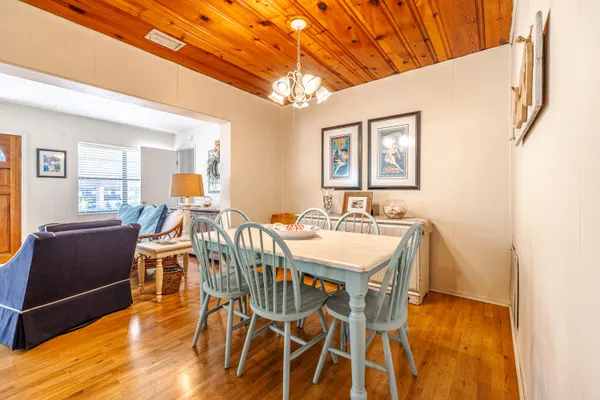 a kitchen with stainless steel appliances kitchen island granite countertop a table and chairs in it