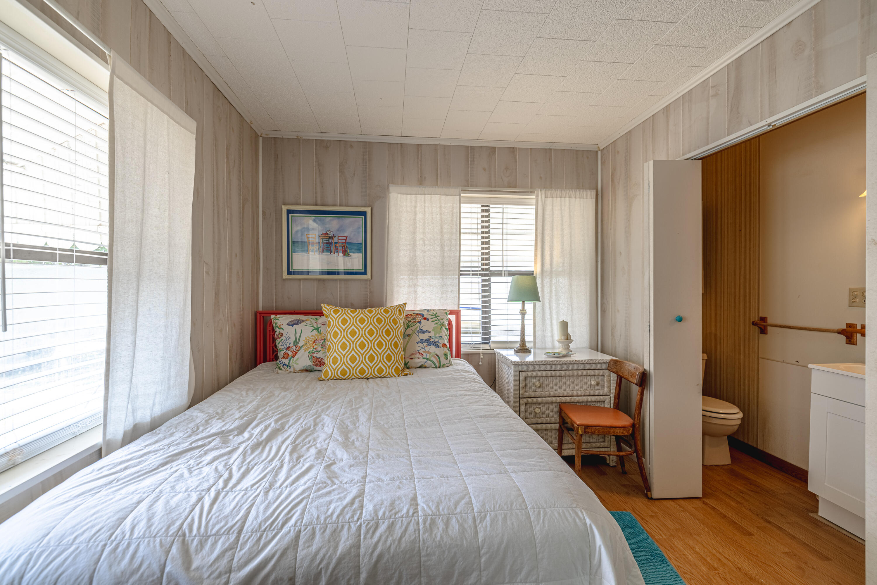 234 Sands Street Panama City Beach, FL 32413 - Photo 21 of 58 a bedroom with a bed and wooden floor