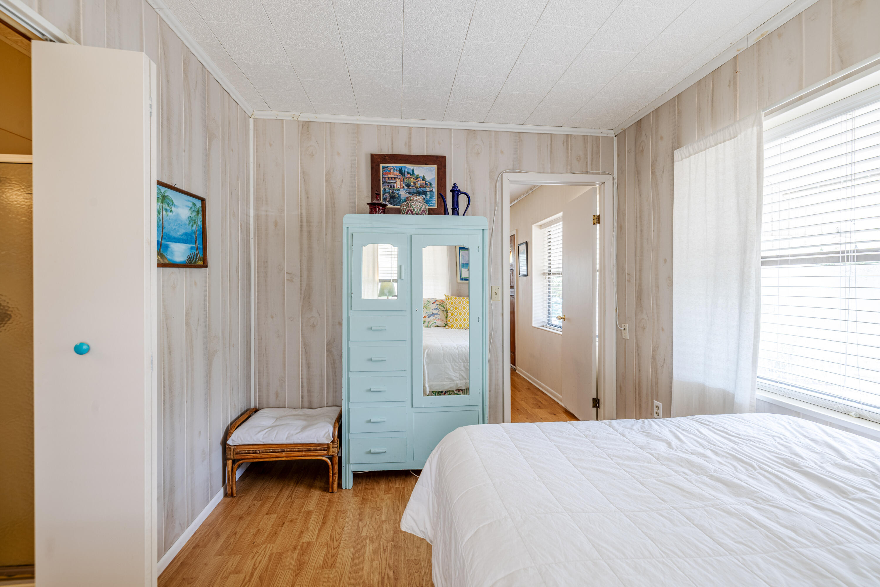 234 Sands Street Panama City Beach, FL 32413 - Photo 23 of 58 a bedroom with a bed and wooden floor