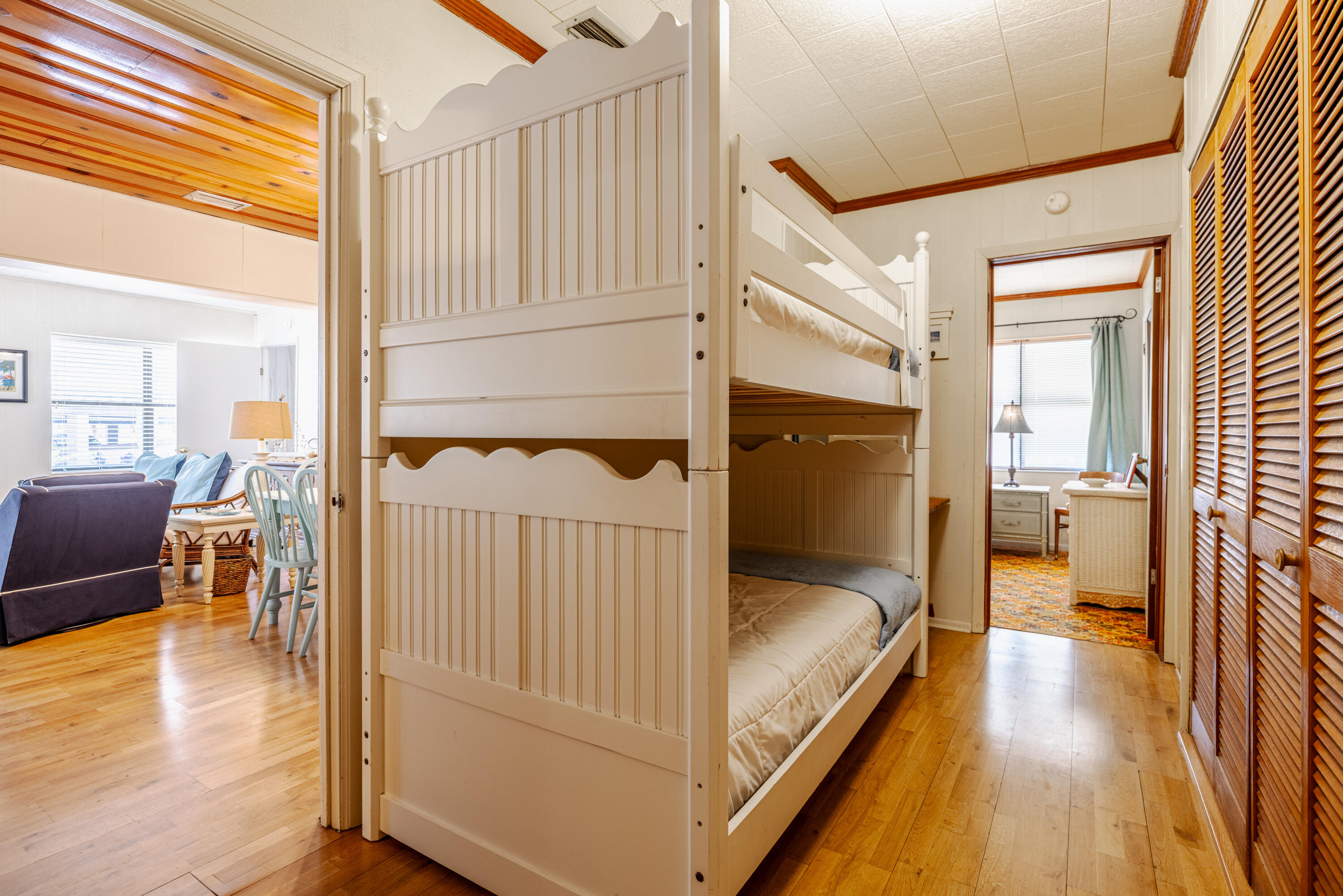 234 Sands Street Panama City Beach, FL 32413 - Photo 27 of 58 a bedroom with a bed and wooden floor