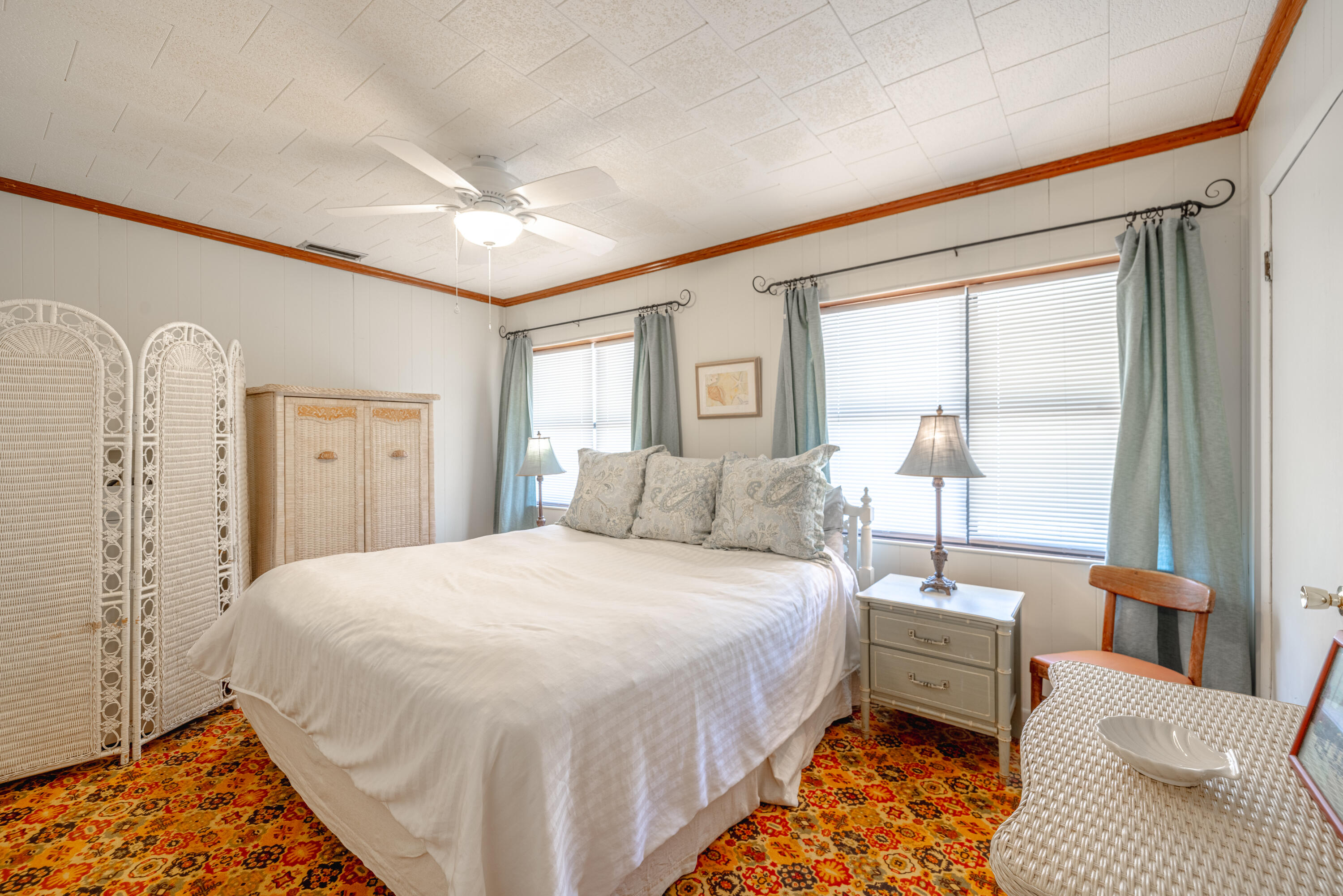234 Sands Street Panama City Beach, FL 32413 - Photo 30 of 58 a spacious bedroom with a bed and a couch