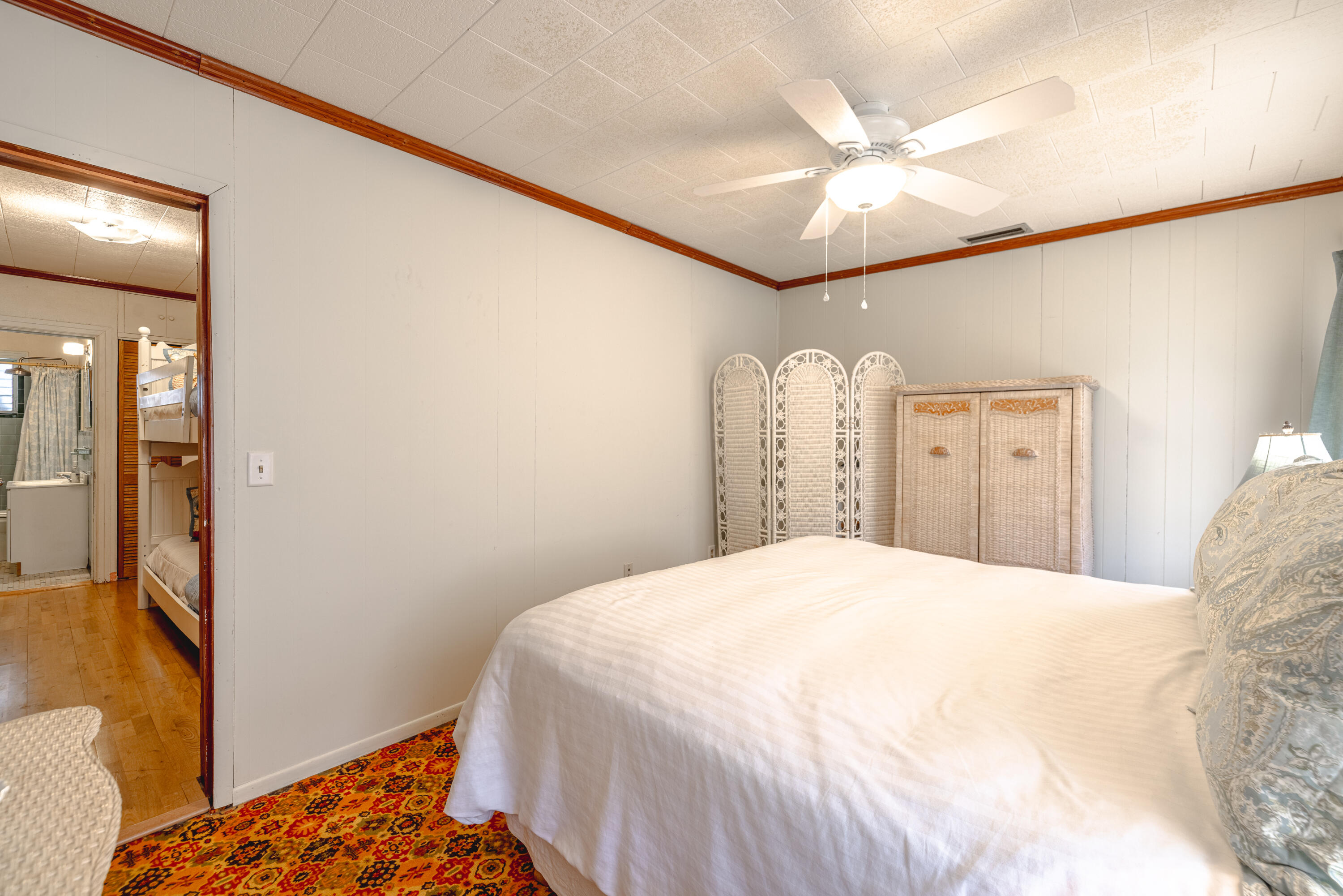 234 Sands Street Panama City Beach, FL 32413 - Photo 31 of 58 a bedroom with a bed and a large mirror on the dresser