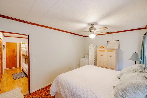 a bedroom with a bed and a chandelier
