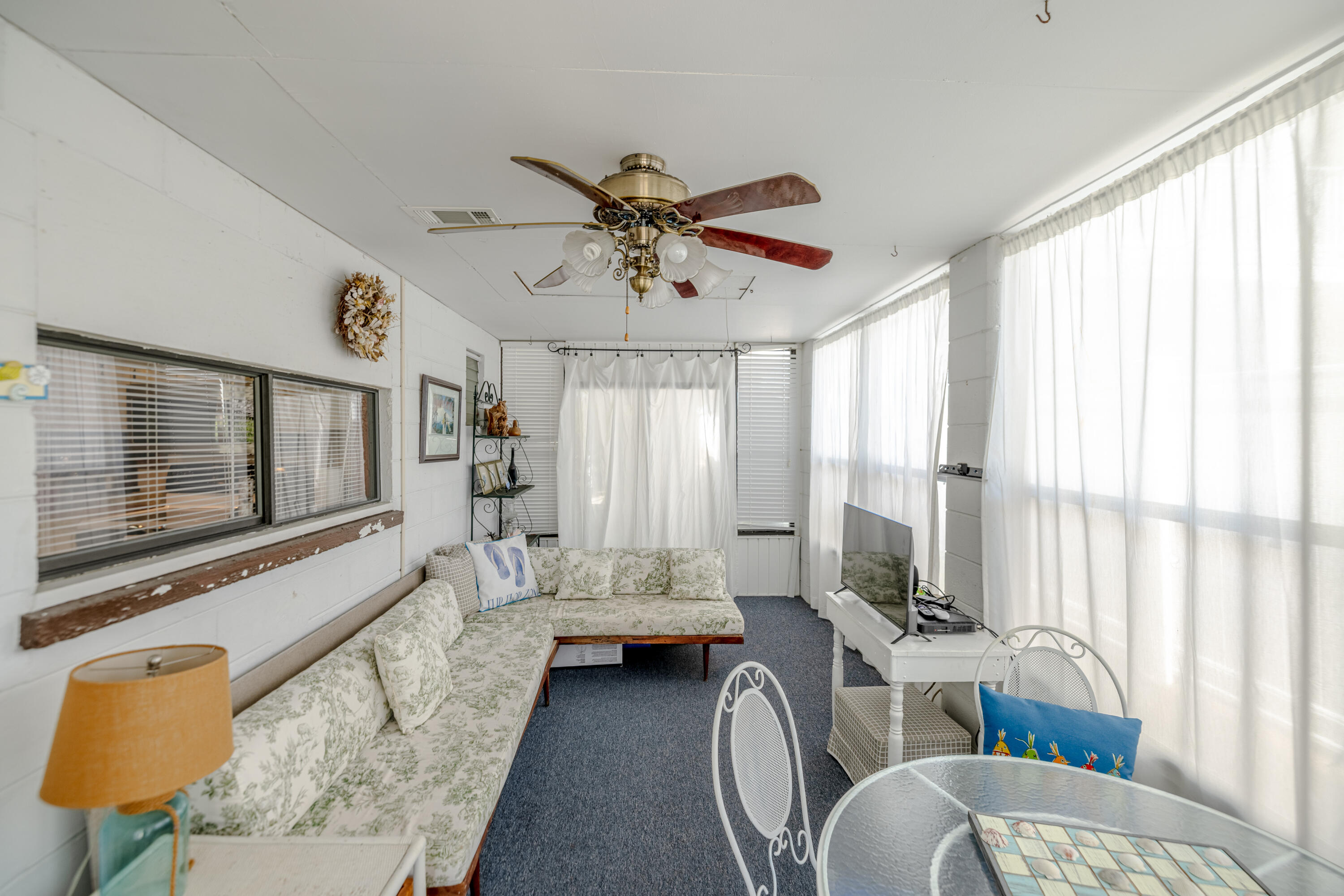 234 Sands Street Panama City Beach, FL 32413 - Photo 33 of 58 a living room with furniture and a flat screen tv