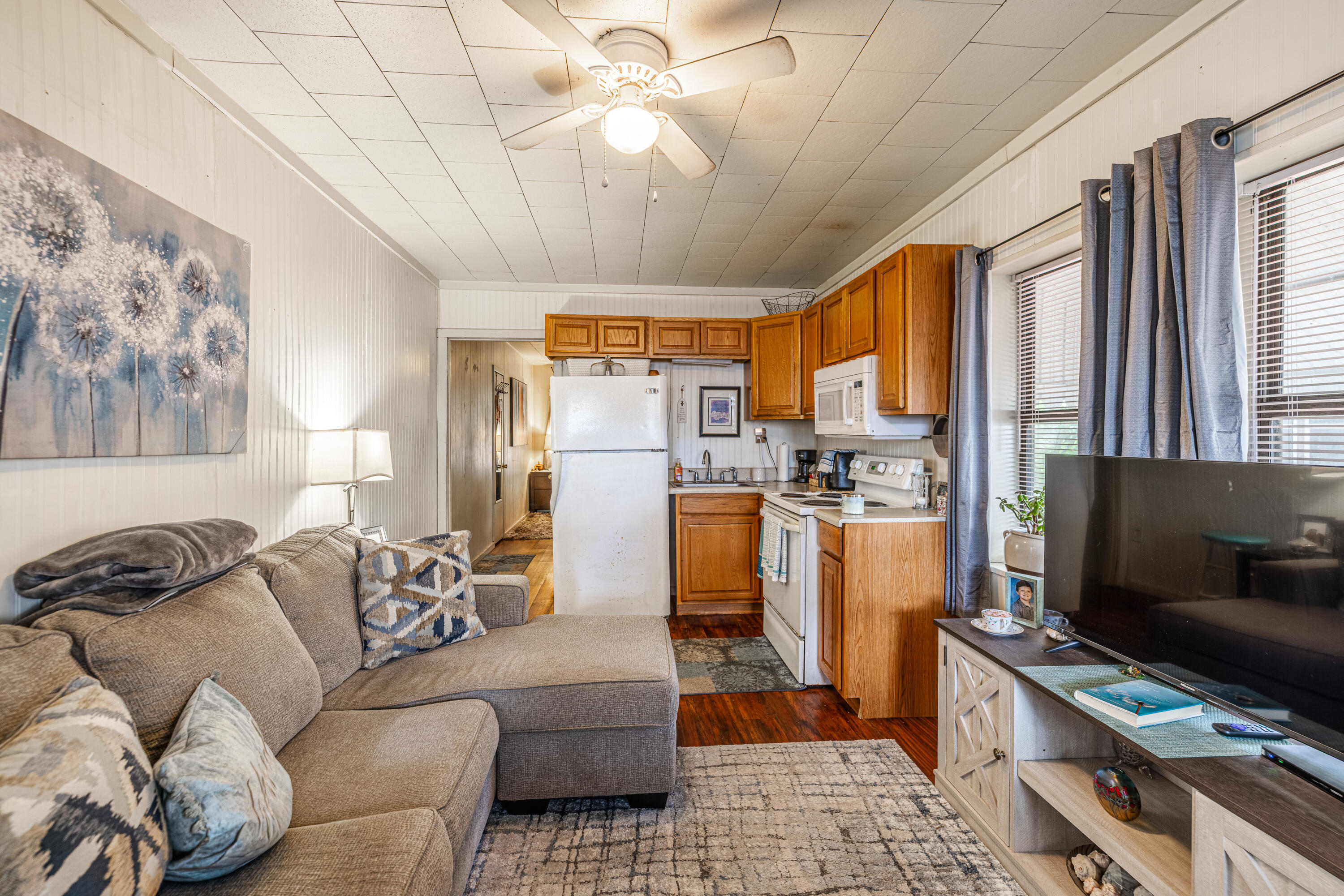 234 Sands Street Panama City Beach, FL 32413 - Photo 39 of 58 a living room with furniture and a flat screen tv