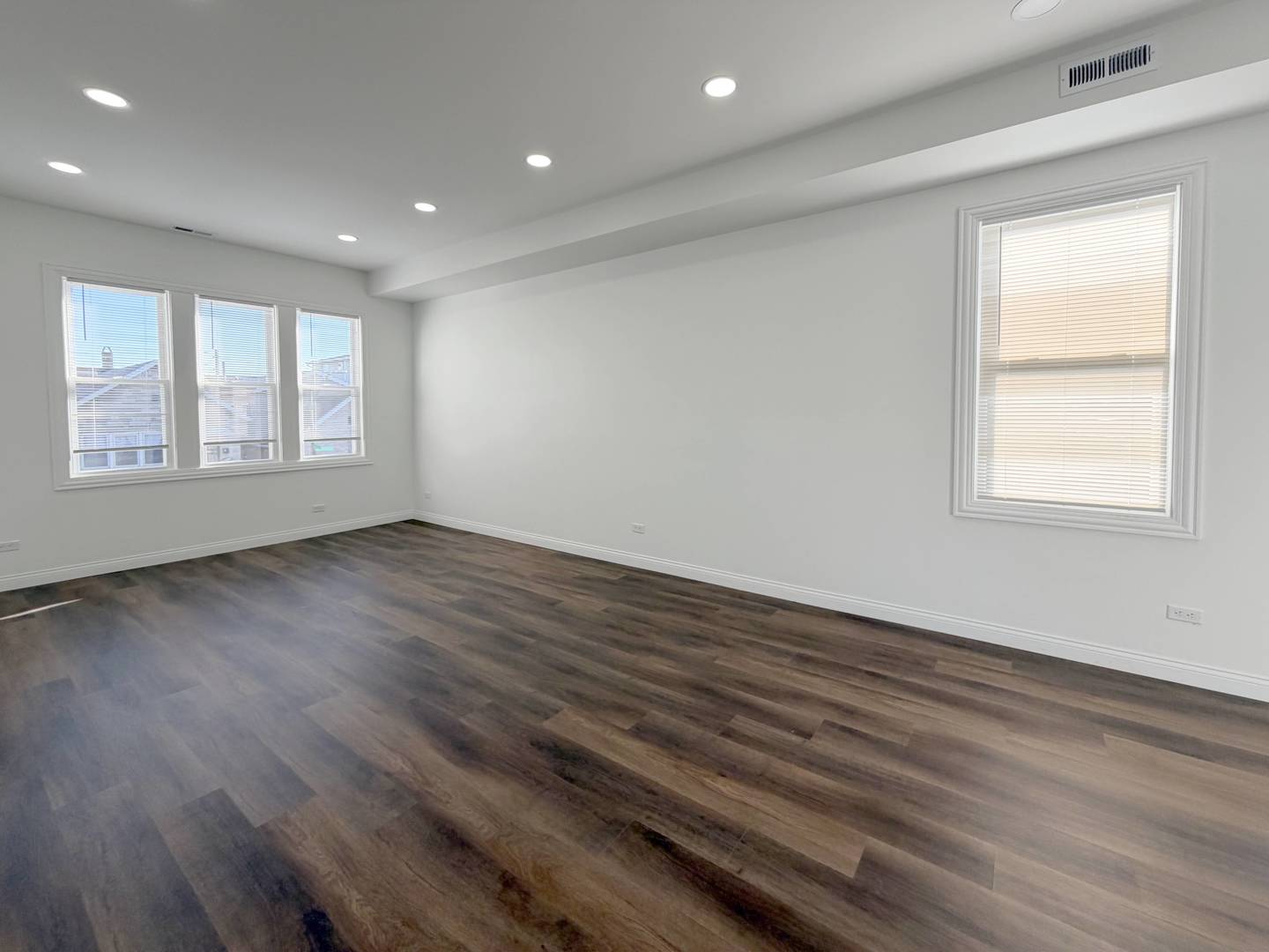 2982 South Lyman Street Chicago, IL 60608 - Photo 19 of 30 an empty room with wooden floor and windows