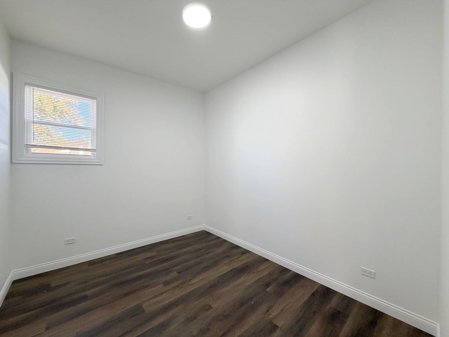 2982 South Lyman Street Chicago, IL 60608 - Photo 26 of 30 a view of an empty room with wooden floor and a window