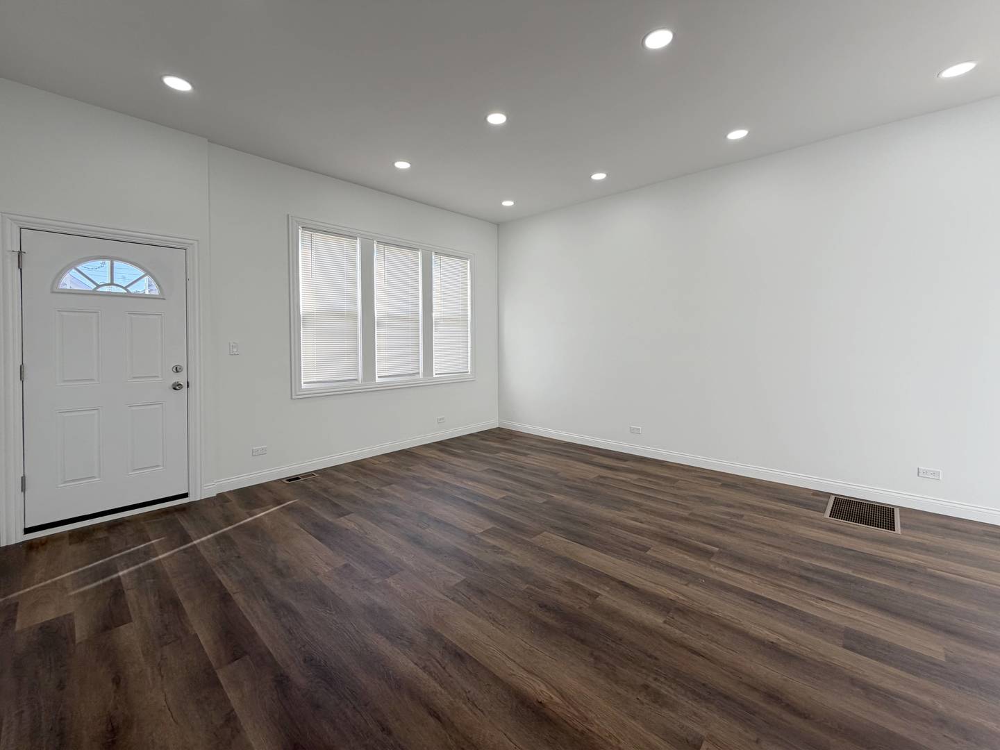 2982 South Lyman Street Chicago, IL 60608 - Photo 5 of 30 an empty room with wooden floor and windows