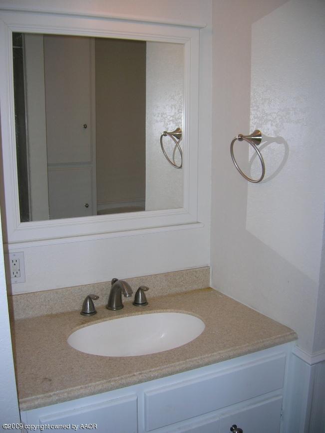 4116 South Lipscomb Street Amarillo, TX 79110 - Photo 8 of 10 a bathroom with a sink and a mirror