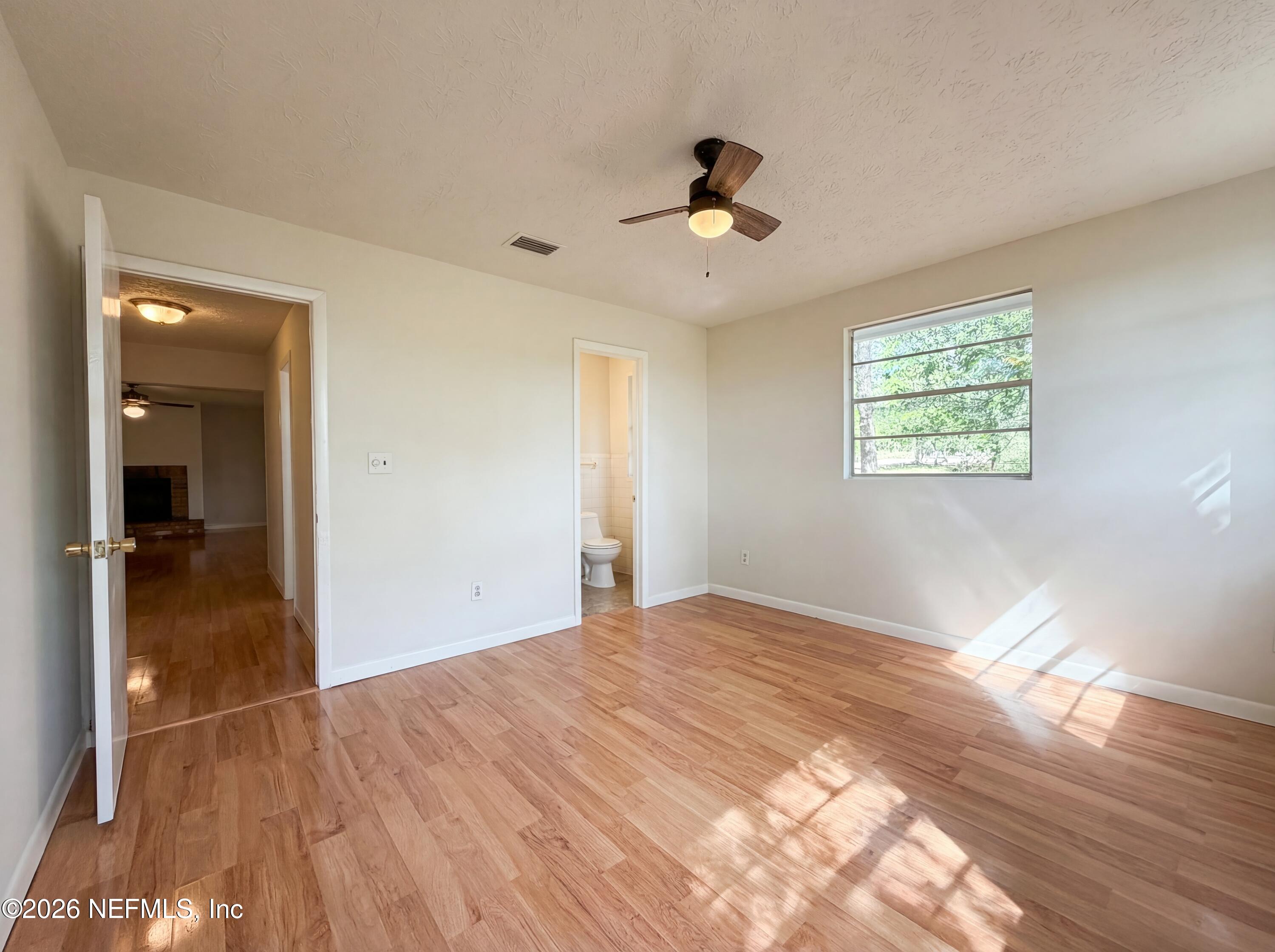 6917 Gatorbone Road Keystone Heights, FL 32656 - Photo 16 of 24 a view of empty room with wooden floor and fan