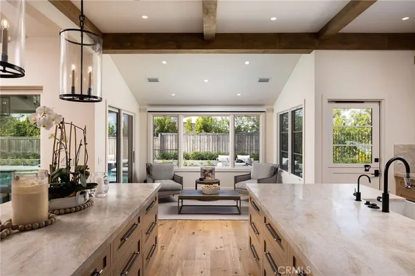 a kitchen with a counter space a sink appliances and cabinets