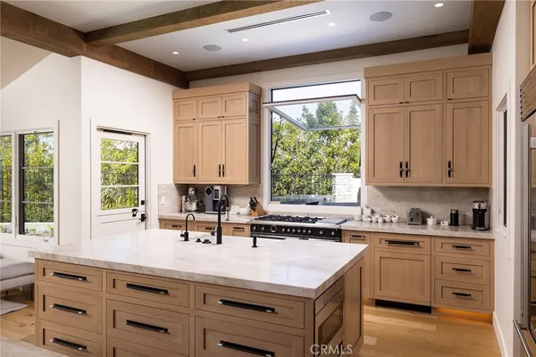 a kitchen with a sink stove and cabinets