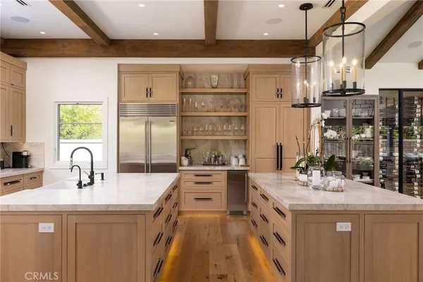 a kitchen with stainless steel appliances a stove sink and cabinets
