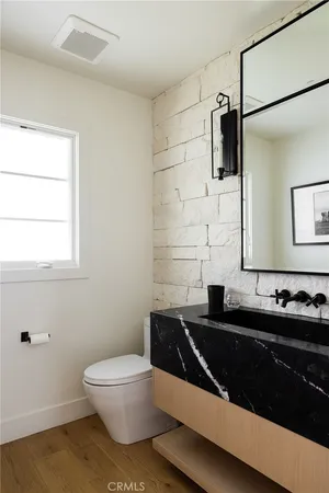 a bathroom with double sink and a mirror