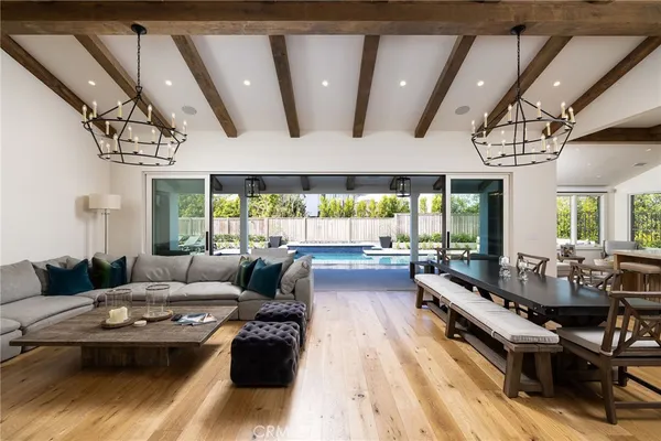 a living room with furniture a flat screen tv and a window
