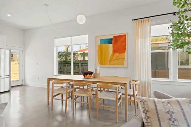 a dining room with furniture and window