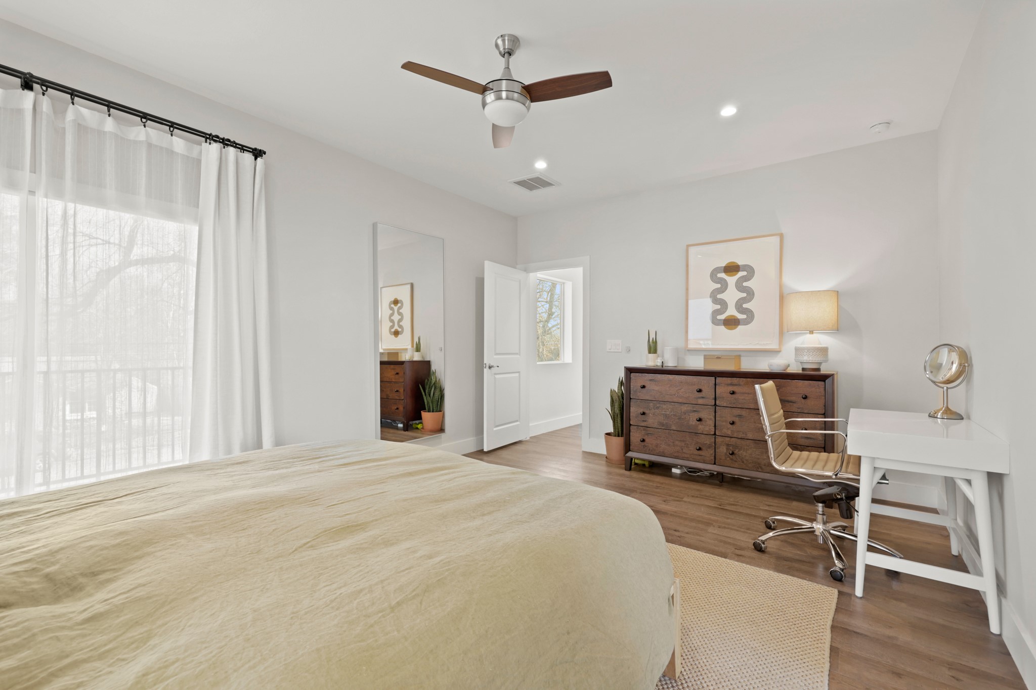 1102 1/2 Tillery Street, Unit 1 Austin, TX 78702 - Photo 22 of 38 a bedroom with a bed and a chandelier