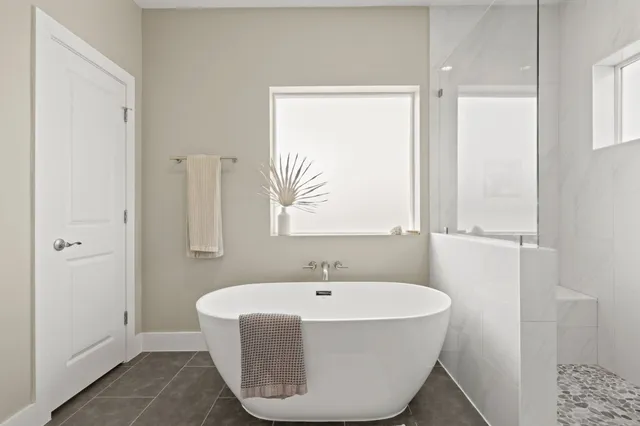 a bathroom with a bathtub and a window