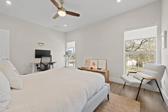 a bedroom with a bed and chair