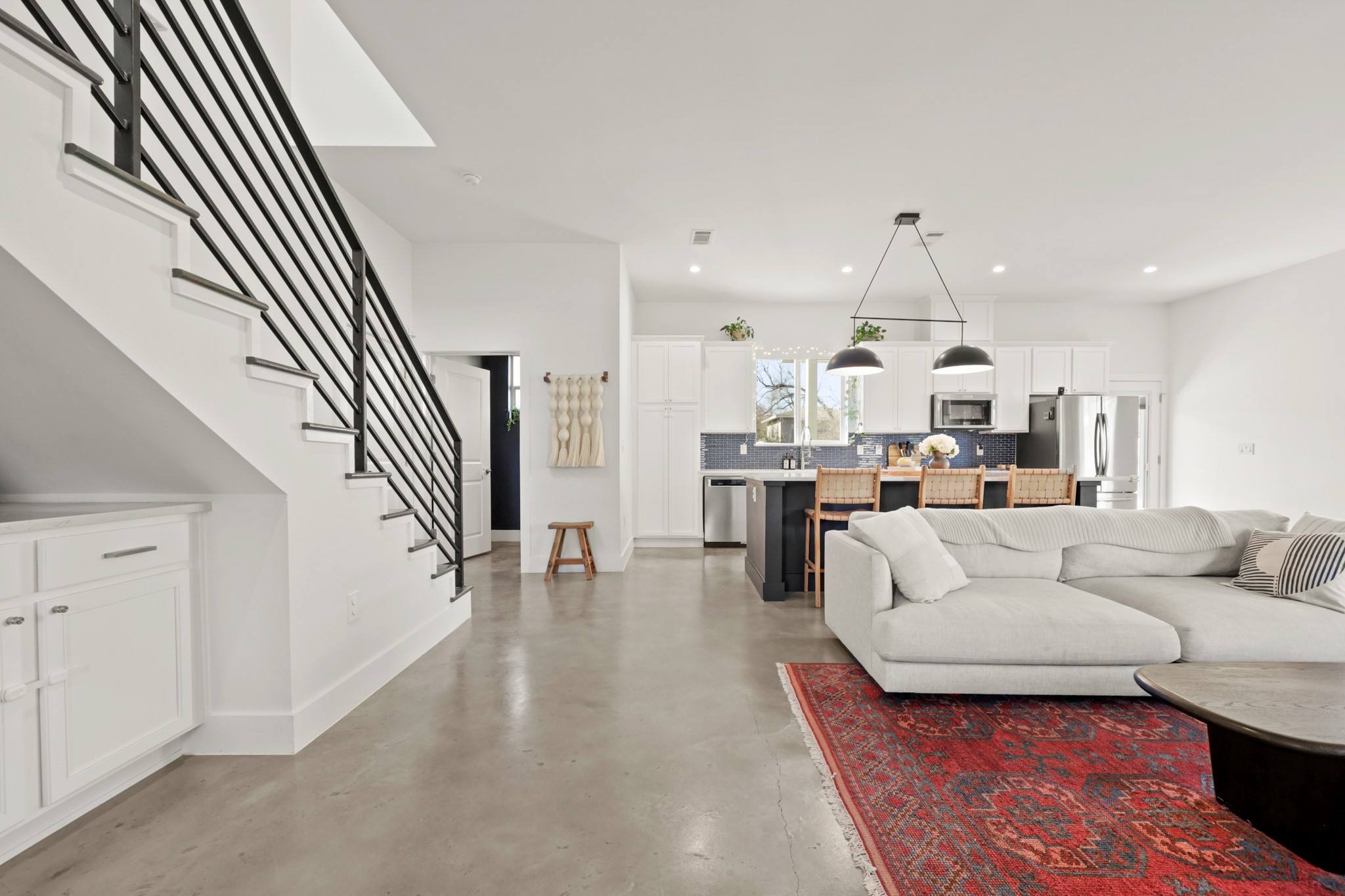 1102 1/2 Tillery Street, Unit 1 Austin, TX 78702 - Photo 6 of 38 a living room with furniture and a chandelier