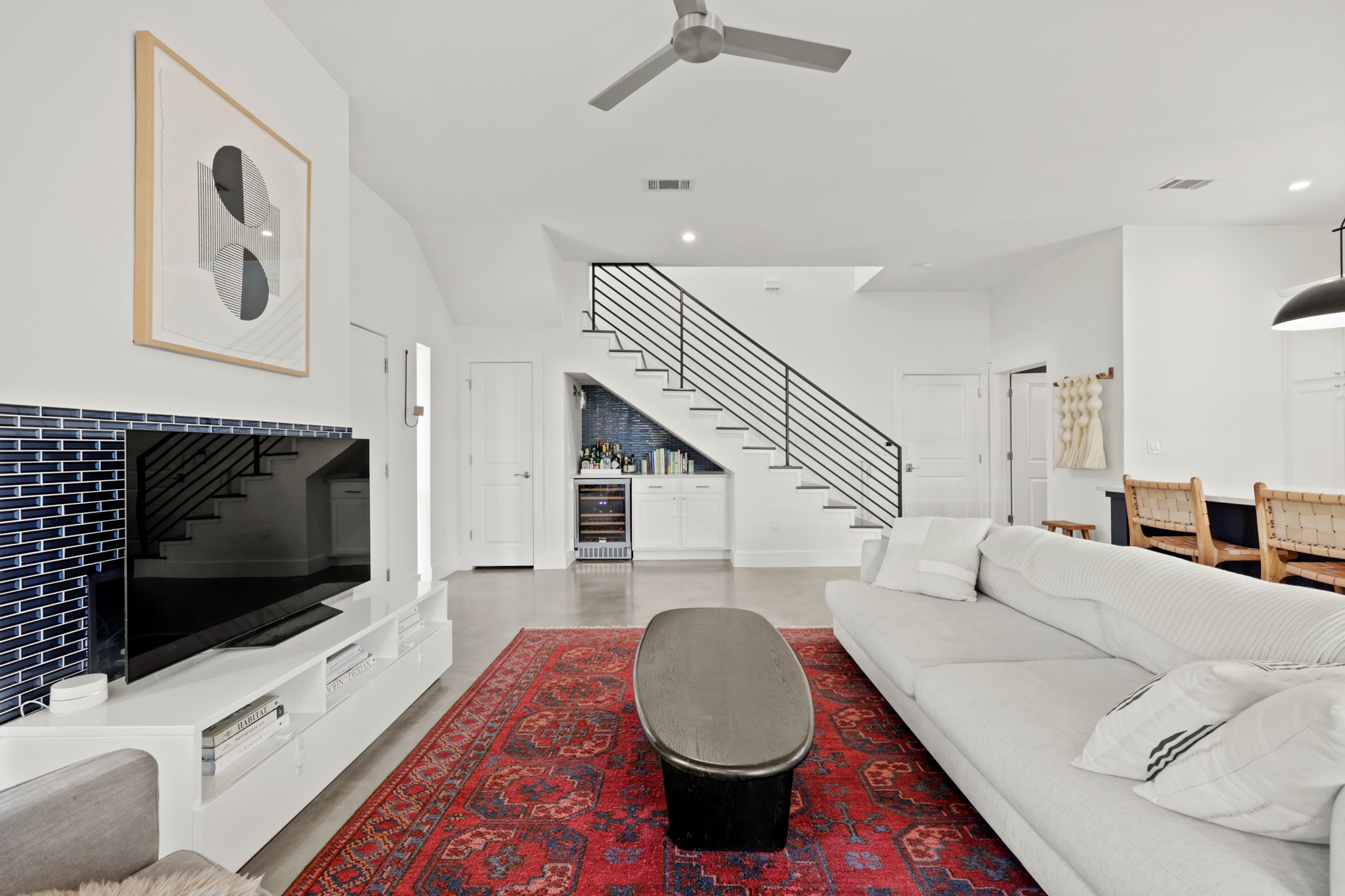 1102 1/2 Tillery Street, Unit 1 Austin, TX 78702 - Photo 10 of 38 a living room with furniture a flat screen tv and kitchen view