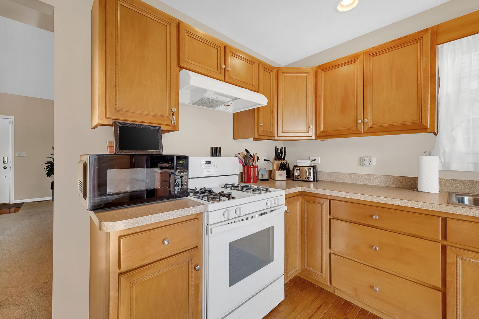 220 South Will Road, Unit 2 Diamond, IL 60416 - Photo 11 of 26 a kitchen with a sink a stove and cabinets