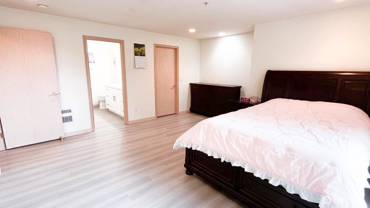 1001 West Casino Road, Unit G303 Everett, WA 98204 - Photo 12 of 22 a large bed sitting in a bedroom next to a window