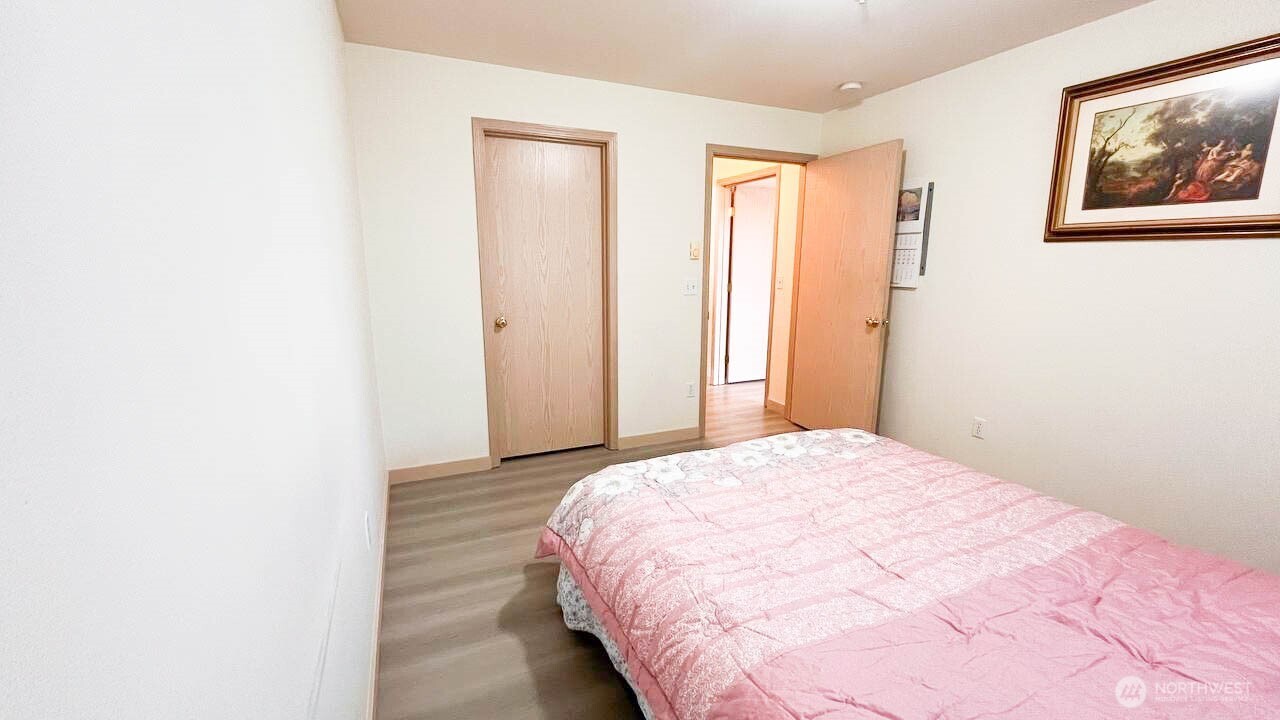1001 West Casino Road, Unit G303 Everett, WA 98204 - Photo 16 of 22 a large bed in a bedroom next to a window