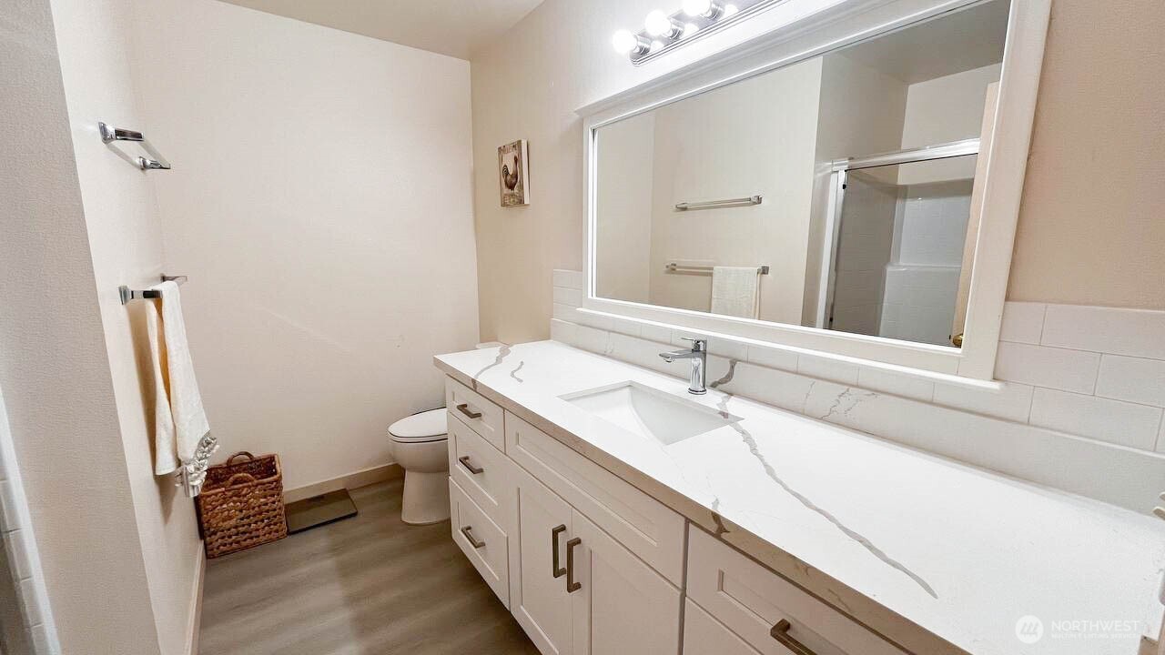 1001 West Casino Road, Unit G303 Everett, WA 98204 - Photo 18 of 22 a bathroom with a double vanity sink and mirror