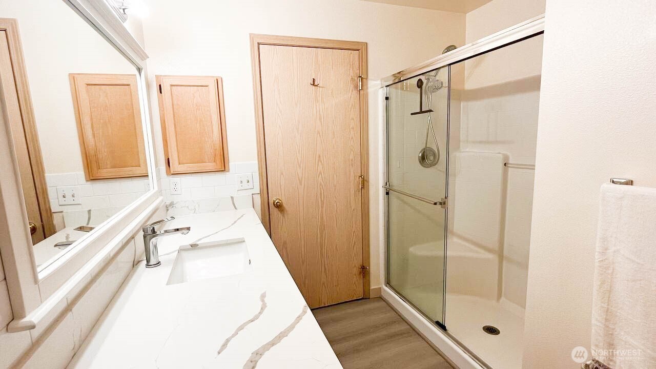 1001 West Casino Road, Unit G303 Everett, WA 98204 - Photo 19 of 22 a bathroom with a tub shower and sink