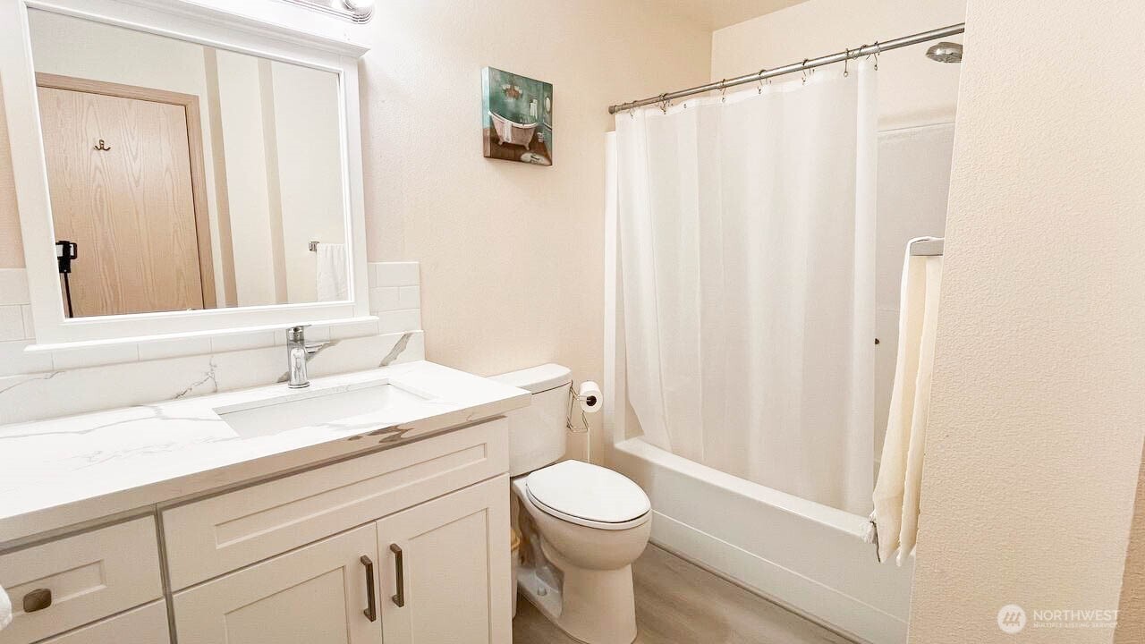 1001 West Casino Road, Unit G303 Everett, WA 98204 - Photo 20 of 22 a bathroom with a granite countertop sink toilet and shower