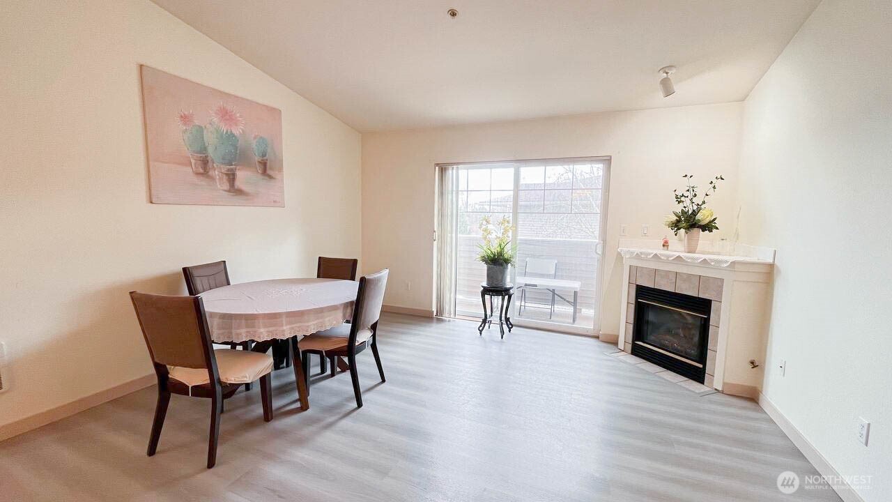 1001 West Casino Road, Unit G303 Everett, WA 98204 - Photo 2 of 22 a view of a dining room with furniture window and wooden floor