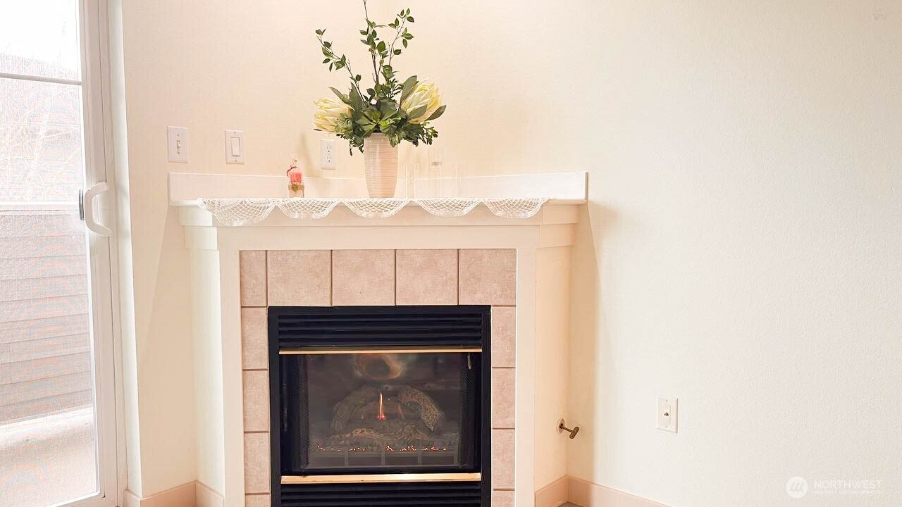 1001 West Casino Road, Unit G303 Everett, WA 98204 - Photo 4 of 22 a room with a fireplace and a potted plant