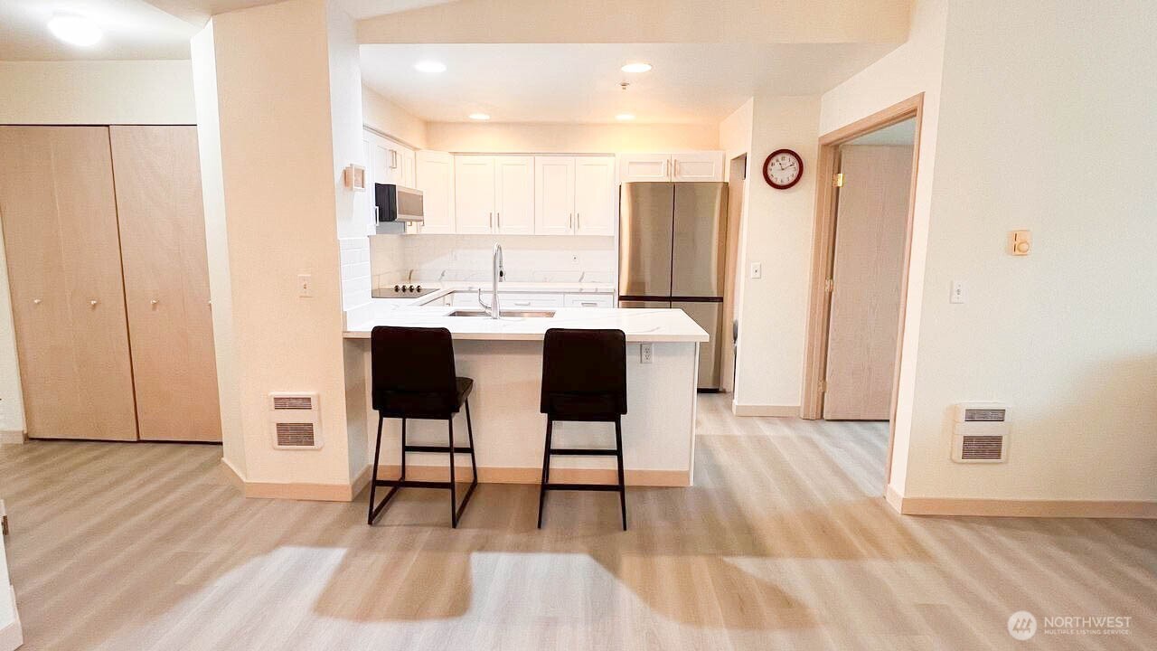 1001 West Casino Road, Unit G303 Everett, WA 98204 - Photo 6 of 22 a dining room with furniture and wooden floor