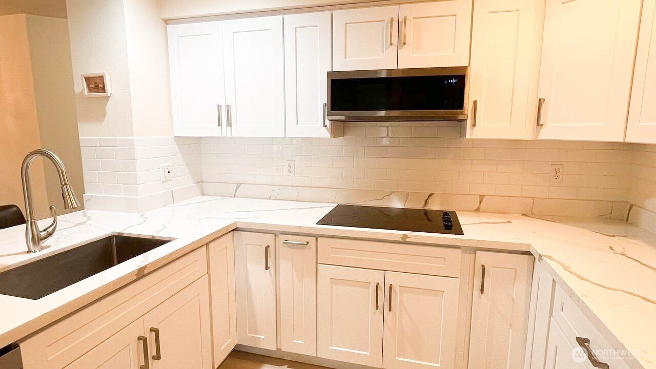 1001 West Casino Road, Unit G303 Everett, WA 98204 - Photo 7 of 22 a kitchen with a sink and a microwave