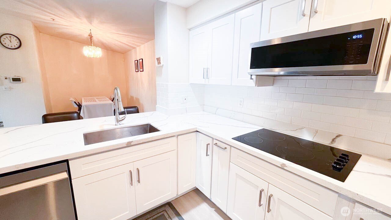 1001 West Casino Road, Unit G303 Everett, WA 98204 - Photo 10 of 22 a kitchen with a sink and cabinets
