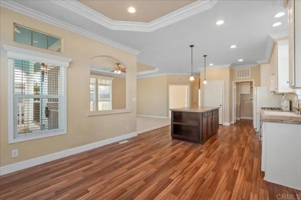 a view of kitchen with cabinets and wooden floor