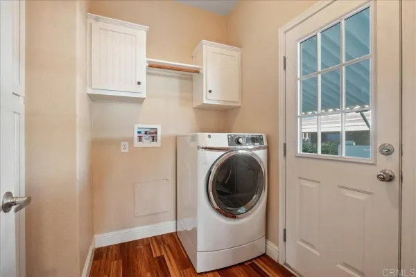 a utility room with sink dryer and washer