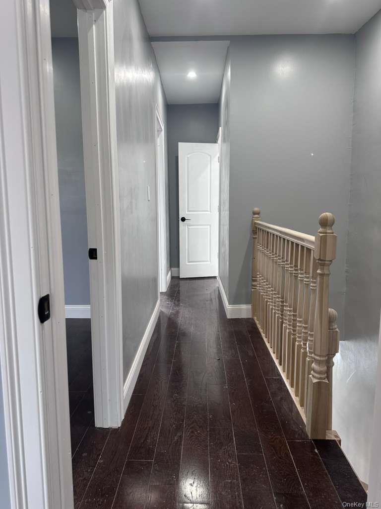 114-06 Inwood Street Queens, NY 11436 - Photo 14 of 18 Hallway featuring an upstairs landing, dark wood-type flooring, and recessed lighting