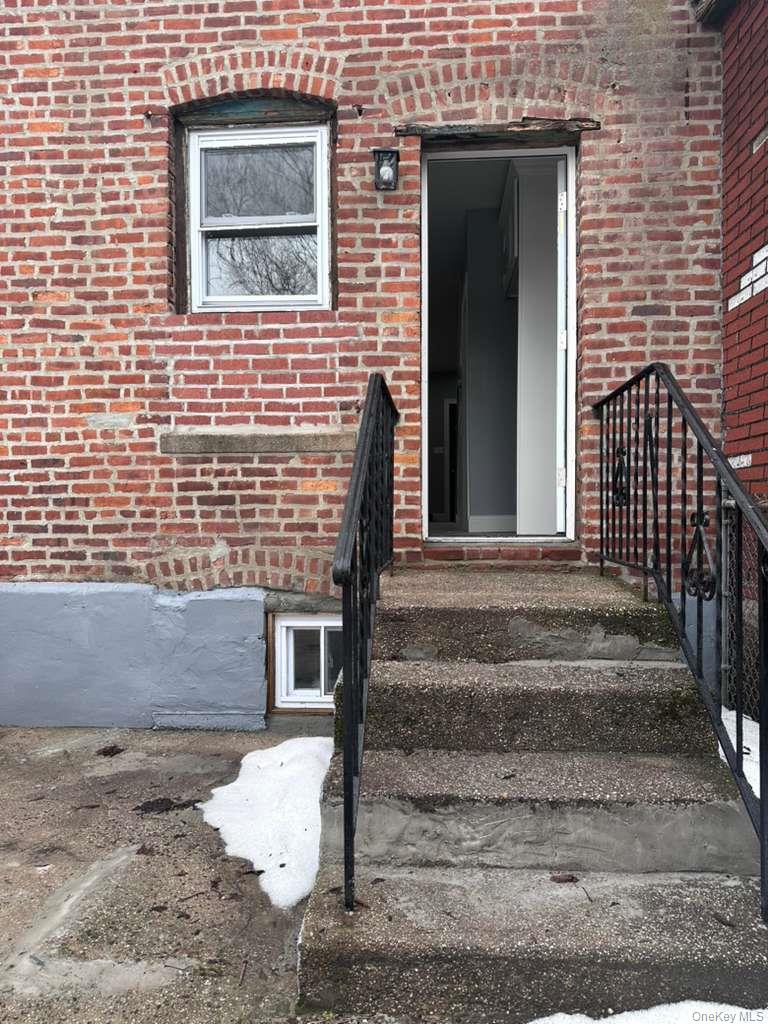 114-06 Inwood Street Queens, NY 11436 - Photo 16 of 18 Property entrance featuring brick siding