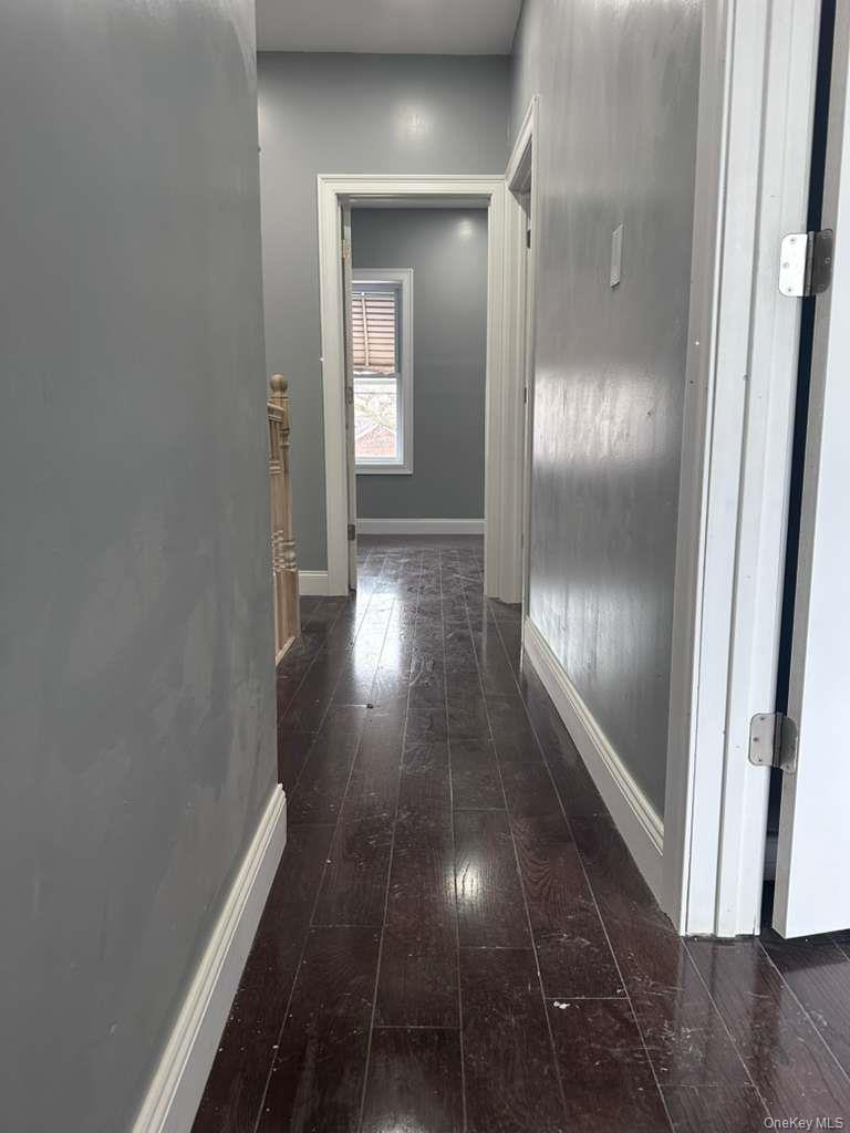114-06 Inwood Street Queens, NY 11436 - Photo 8 of 18 Hall with dark wood-type flooring and baseboards