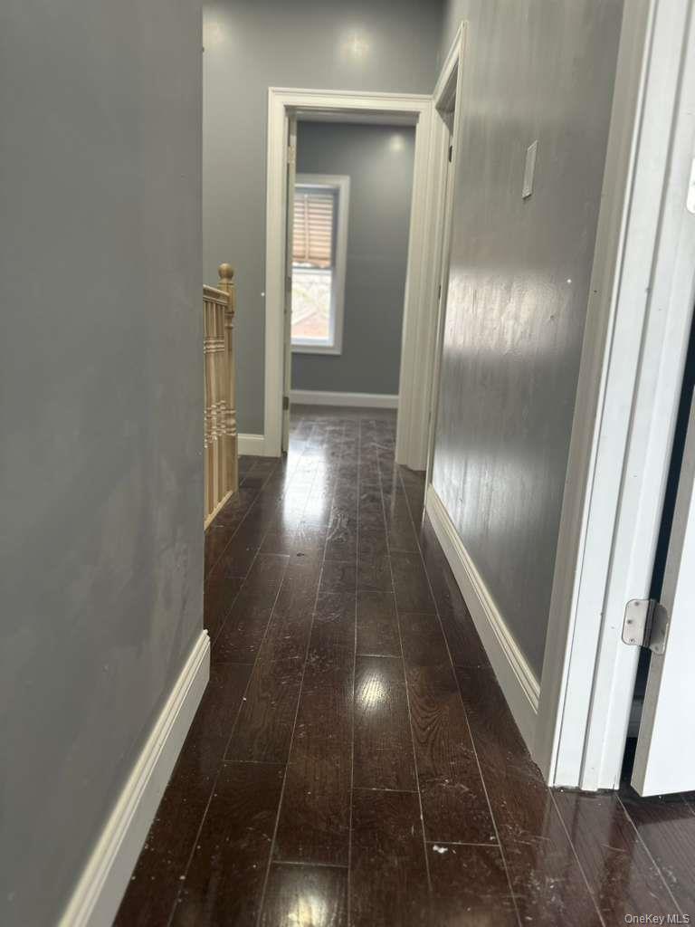 114-06 Inwood Street Queens, NY 11436 - Photo 9 of 18 Hallway with dark wood finished floors and baseboards
