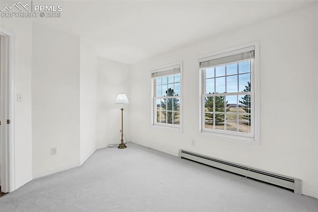 3954 County Rd KK 75 Fowler, CO 81039 - Photo 26 of 41 Unfurnished room featuring a baseboard heating unit, carpet, and baseboards