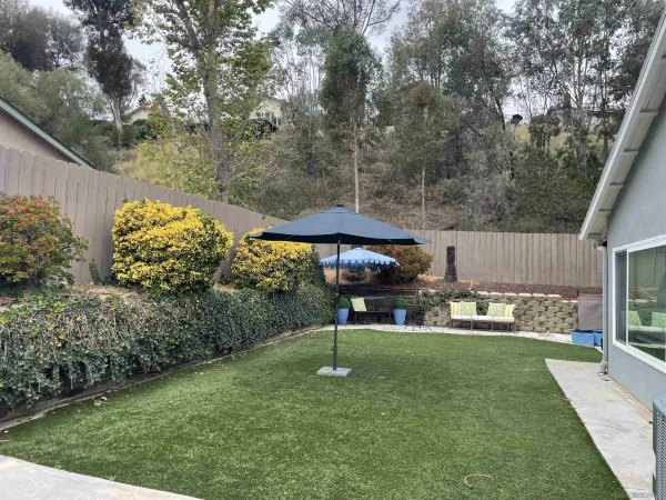a view of a patio with couches table and chairs and potted plants