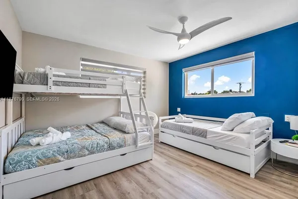a bedroom with a bed and a painting on the wall